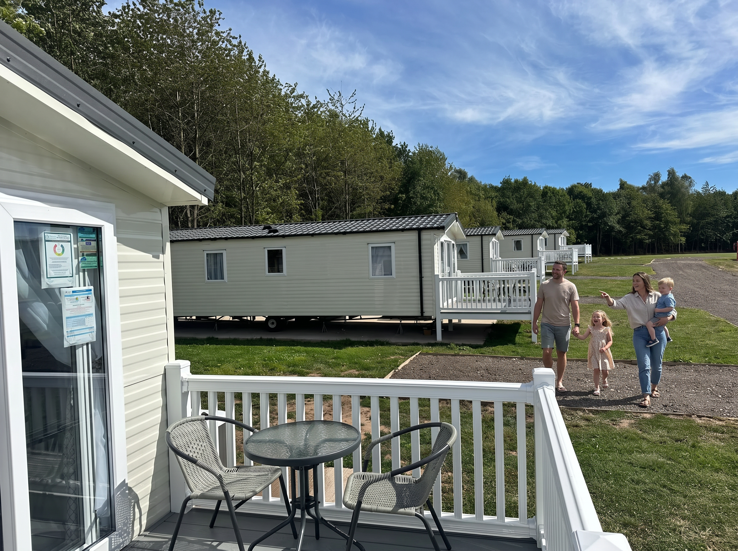 A family walking past the holiday lodges at Swanlake